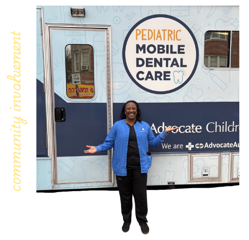 Dr. Ayanna smiling in front of the Pediatric mobile dental care bus to support community involvement